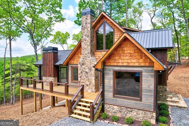 171 Antler Way, Morganton, GA 30560 - rustic home featuring a chimney, stone siding, a wooden deck, and metal roof