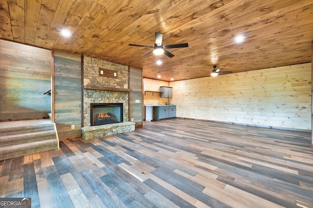 171 Antler Way, Morganton, GA 30560 - unfurnished living room with wooden ceiling, wood finished floors, ceiling fan, stairs, and a stone fireplace