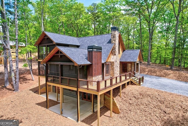 171 Antler Way, Morganton, GA 30560 - back of property featuring roof with shingles, a chimney, a patio area, stone siding, and a deck