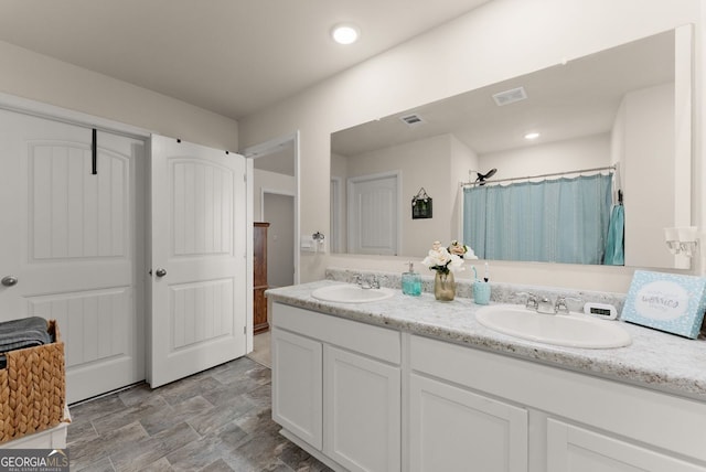 352 Walnut Grove Way, Pendergrass, GA 30567 - bathroom with double vanity, a shower with curtain, stone finish floors, and recessed lighting