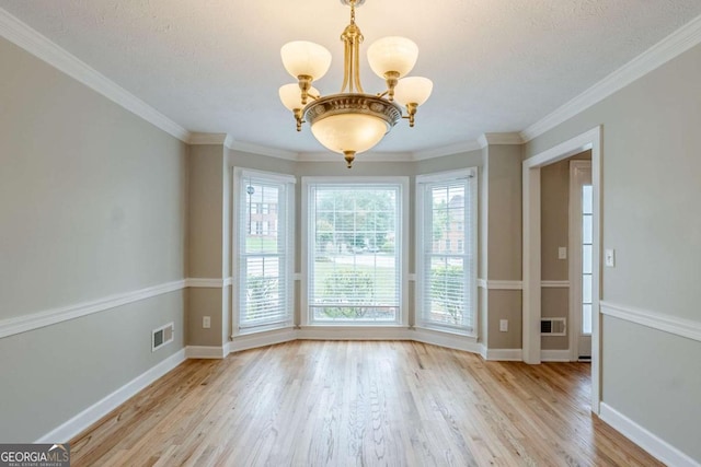 5611 Manassas Run, Stone Mountain, GA 30087 - unfurnished dining area with visible vents, light wood-type flooring, baseboards, an inviting chandelier, and ornamental molding