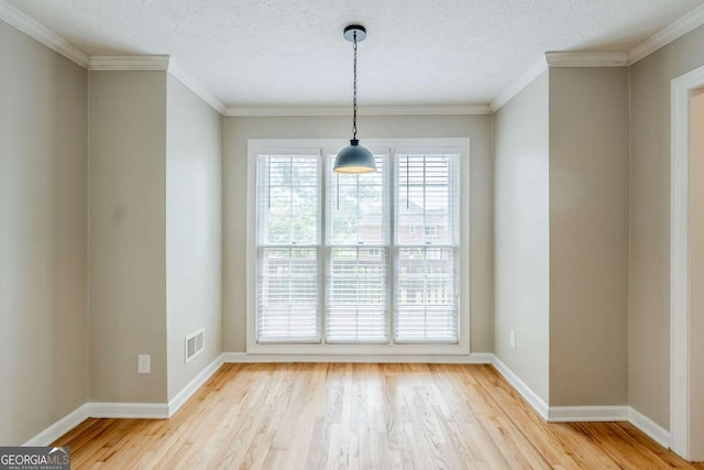 5611 Manassas Run, Stone Mountain, GA 30087 - unfurnished dining area featuring crown molding, baseboards, visible vents, and light wood-type flooring