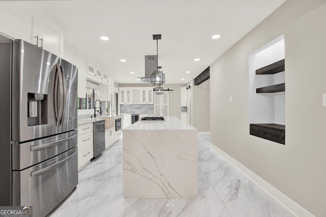kitchen with open shelves, a kitchen island, glass insert cabinets, white cabinetry, and appliances with stainless steel finishes