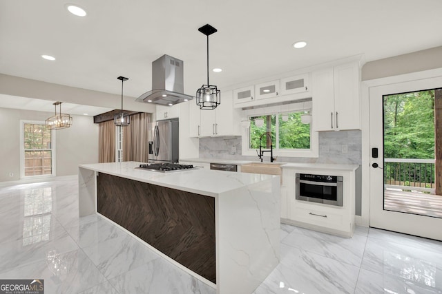 kitchen featuring a sink, stainless steel appliances, marble finish floor, and island range hood