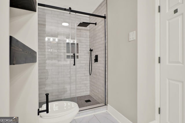 bathroom with baseboards, a stall shower, toilet, and marble finish floor