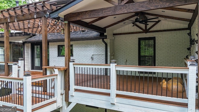 wooden deck featuring ceiling fan and a pergola