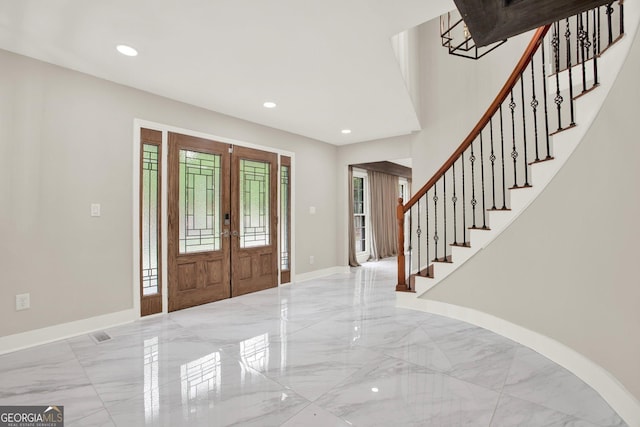 foyer entrance with french doors, marble finish floor, recessed lighting, baseboards, and stairway