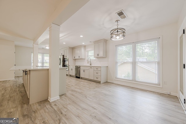 9985 Lake Forest Way, Roswell, GA 30076 - kitchen with light countertops, visible vents, stainless steel appliances, and a wealth of natural light