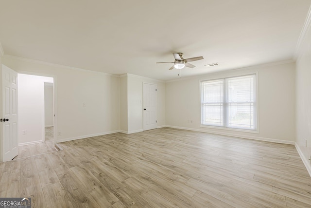 9985 Lake Forest Way, Roswell, GA 30076 - spare room with crown molding, visible vents, baseboards, a ceiling fan, and light wood-style flooring