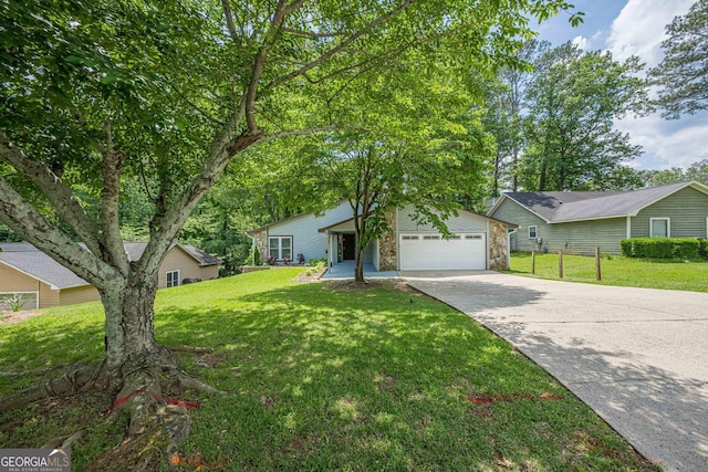 9985 Lake Forest Way, Roswell, GA 30076 - view of front of home featuring a garage, fence, stone siding, a front yard, and driveway
