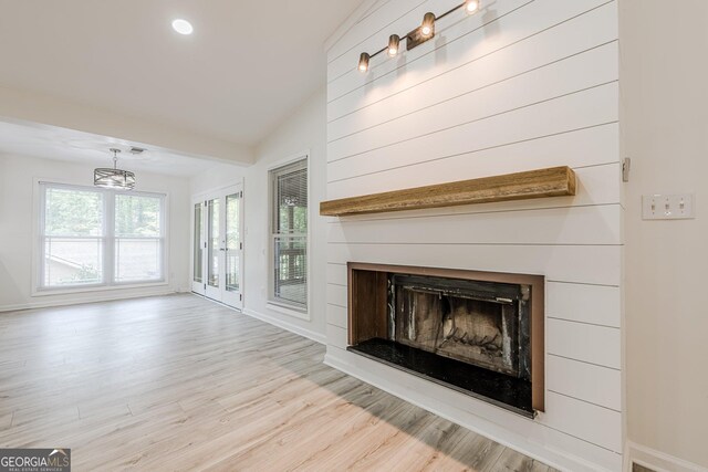 9985 Lake Forest Way, Roswell, GA 30076 - unfurnished living room featuring baseboards, a fireplace, wood finished floors, and a chandelier