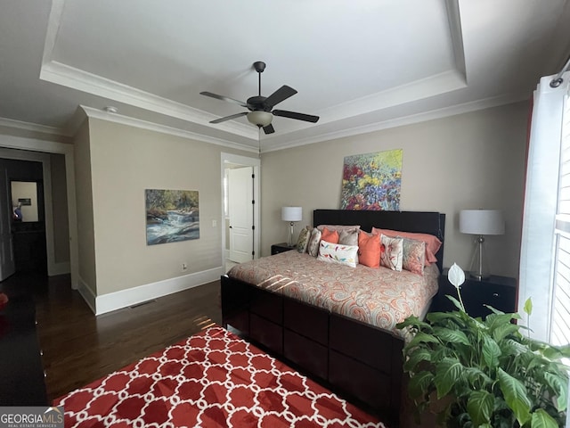 2220 Cambridge Hill Ct, Dacula, GA 30019 - bedroom featuring a raised ceiling, dark wood-type flooring, baseboards, crown molding, and ceiling fan