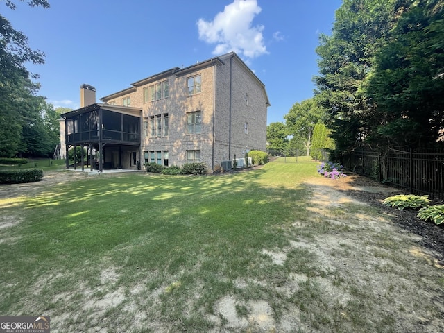 2220 Cambridge Hill Ct, Dacula, GA 30019 - back of house featuring a sunroom and a chimney