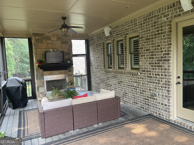 2220 Cambridge Hill Ct, Dacula, GA 30019 - living room featuring crown molding, ceiling fan, brick wall, and an outdoor stone fireplace