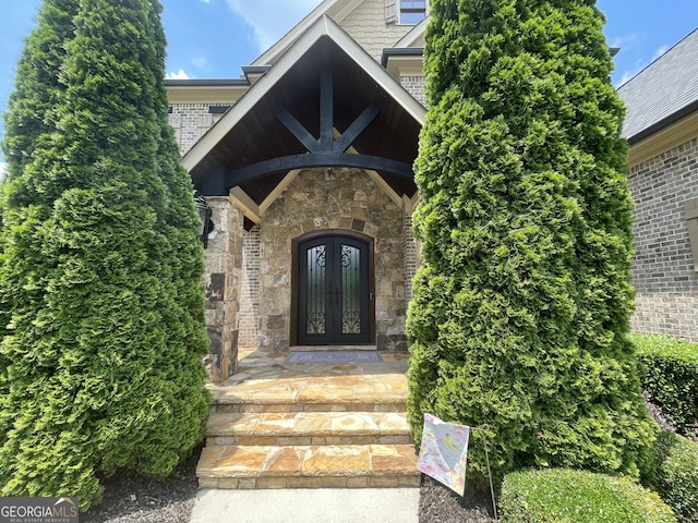 2220 Cambridge Hill Ct, Dacula, GA 30019 - entrance to property featuring french doors, stone siding, and brick siding