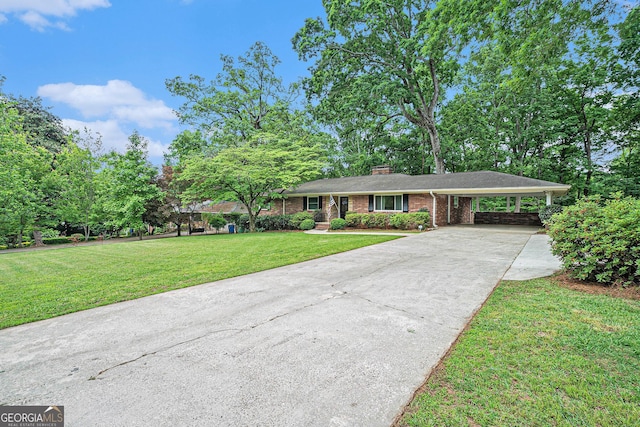 single story home with brick siding, driveway, a chimney, a front yard, and a carport