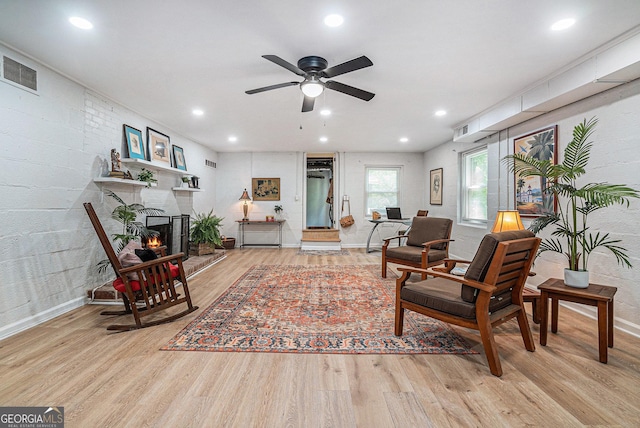 living room with wood finished floors, baseboards, ceiling fan, recessed lighting, and a fireplace