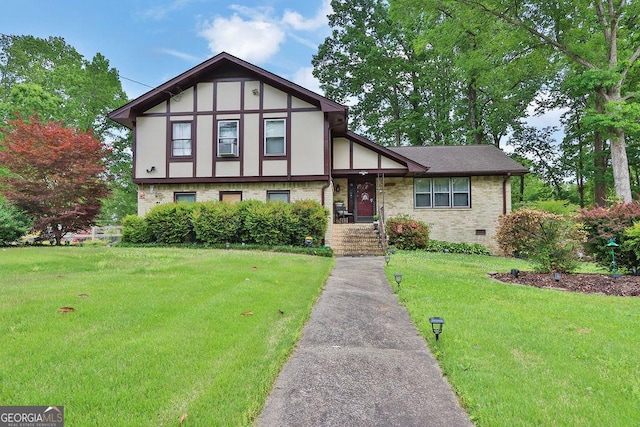 view of front of home with a front lawn and brick siding