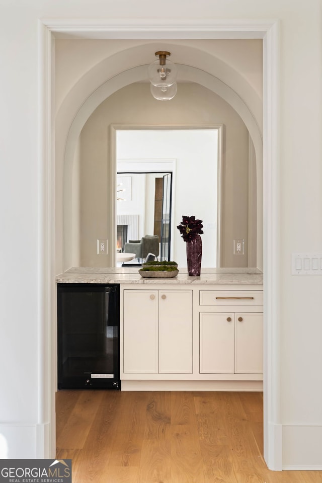 490 Mount Paran Rd, Atlanta, GA 30327 - bar featuring wine cooler, light wood-type flooring, and arched walkways
