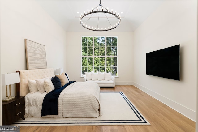 490 Mount Paran Rd, Atlanta, GA 30327 - bedroom with a chandelier, vaulted ceiling, light wood-style flooring, and baseboards