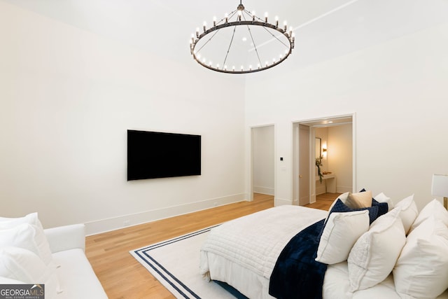 490 Mount Paran Rd, Atlanta, GA 30327 - bedroom with a chandelier, light wood-type flooring, baseboards, and connected bathroom