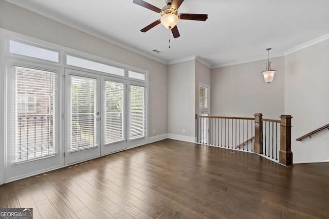 empty room featuring crown molding, ceiling fan, and wood finished floors