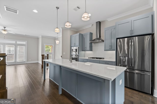 kitchen featuring crown molding, appliances with stainless steel finishes, wall chimney exhaust hood, and visible vents