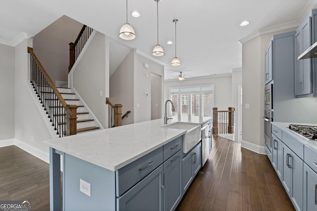 kitchen with baseboards, gray cabinetry, a sink, and dark wood-type flooring