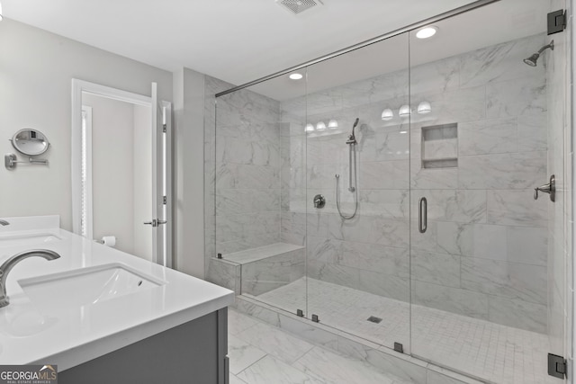 bathroom with recessed lighting, a shower stall, a sink, and marble finish floor