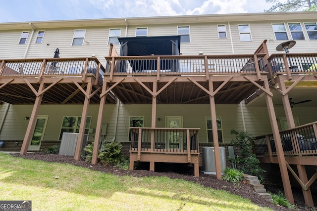 rear view of house featuring a wooden deck and central AC