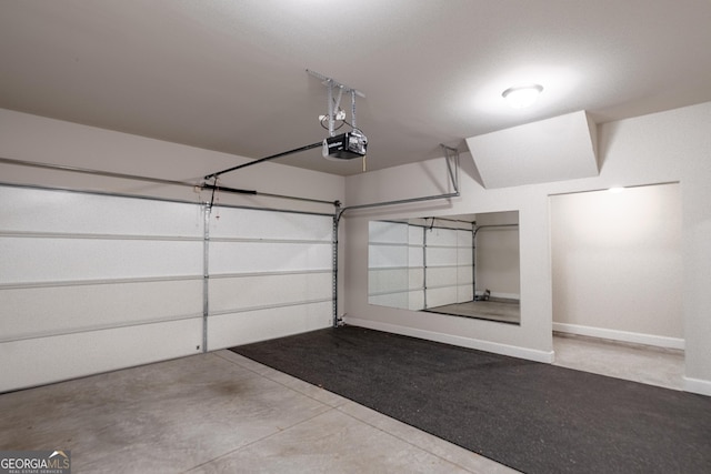 garage featuring baseboards and a garage door opener