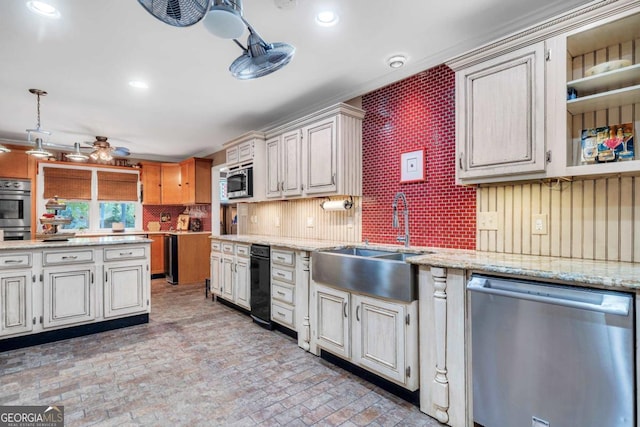 kitchen featuring ceiling fan, light stone countertops, a sink, brick floor, and stainless steel appliances