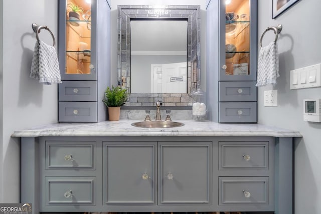 bathroom with ornamental molding and vanity