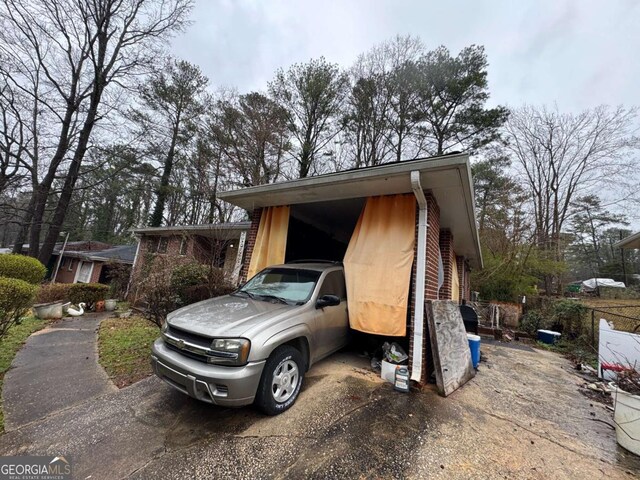 exterior space with a carport and aphalt driveway