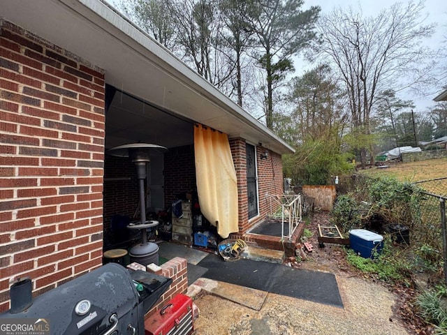 view of side of property with fence and brick siding