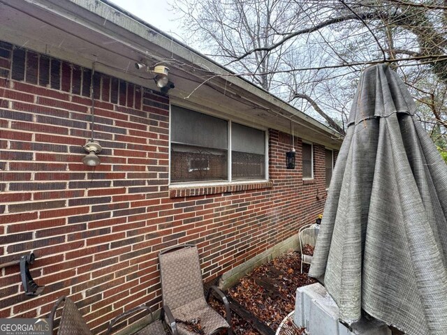 view of side of property featuring brick siding