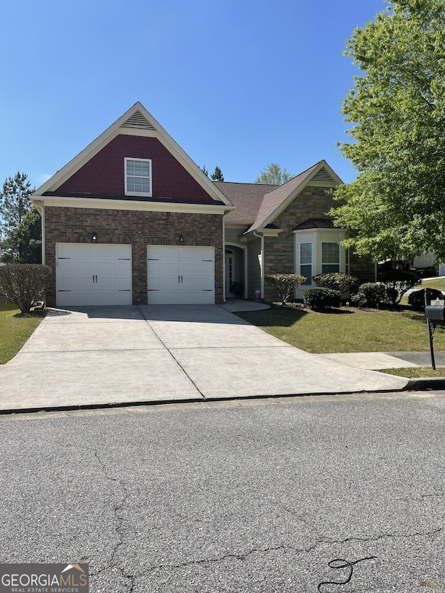 view of front of home with a garage, a front lawn, and driveway