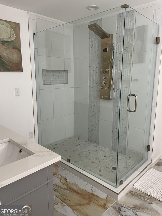 bathroom featuring vanity, marble finish floor, and a stall shower