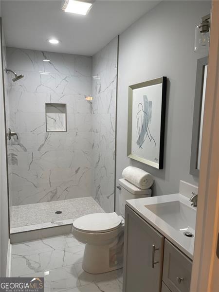 2135 Niskey Lake Rd, Atlanta, GA 30331 - bathroom featuring marble look tiles, vanity, a marble finish shower, and recessed lighting