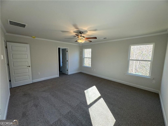 carpeted empty room featuring visible vents, a ceiling fan, and crown molding