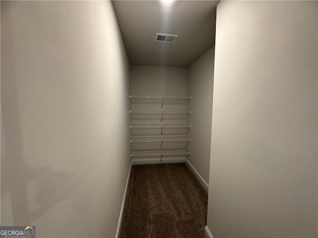 interior space featuring baseboards, carpet, and visible vents