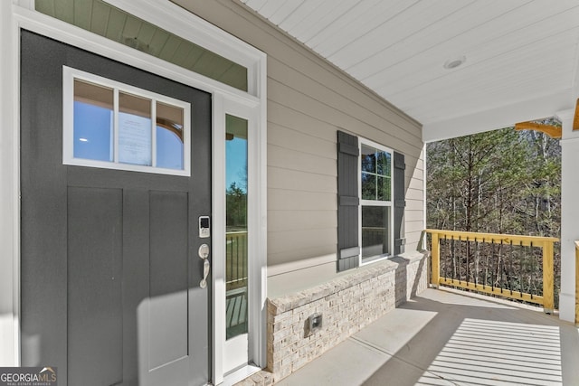 view of exterior entry featuring a porch