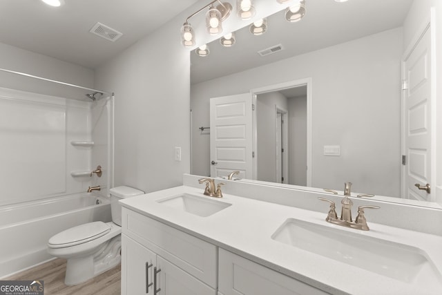 full bath with toilet, visible vents, a sink, and wood finished floors