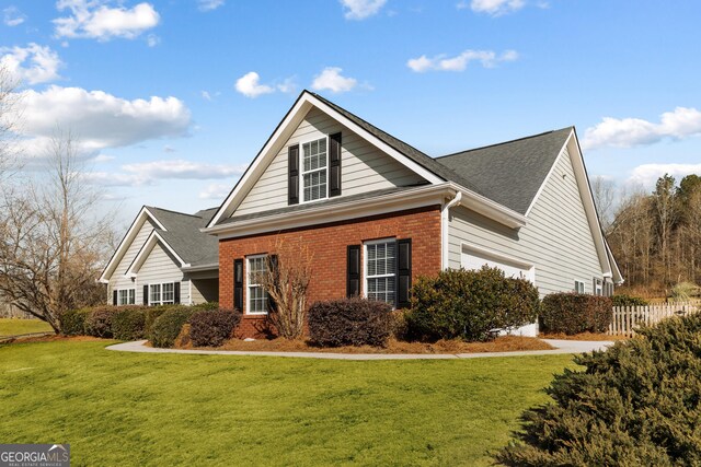 17 Castleview Ct, Jefferson, GA 30549 - view of front of home featuring brick siding, roof with shingles, fence, and a front yard