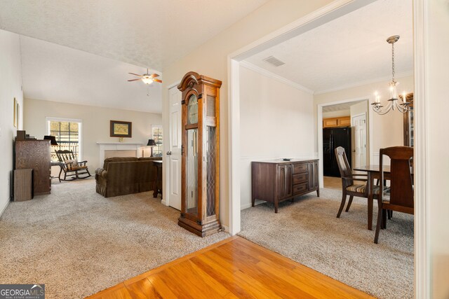 17 Castleview Ct, Jefferson, GA 30549 - hall featuring visible vents, crown molding, light wood-type flooring, a notable chandelier, and light carpet