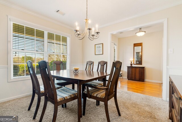 17 Castleview Ct, Jefferson, GA 30549 - dining room featuring a notable chandelier, light colored carpet, baseboards, visible vents, and ornamental molding