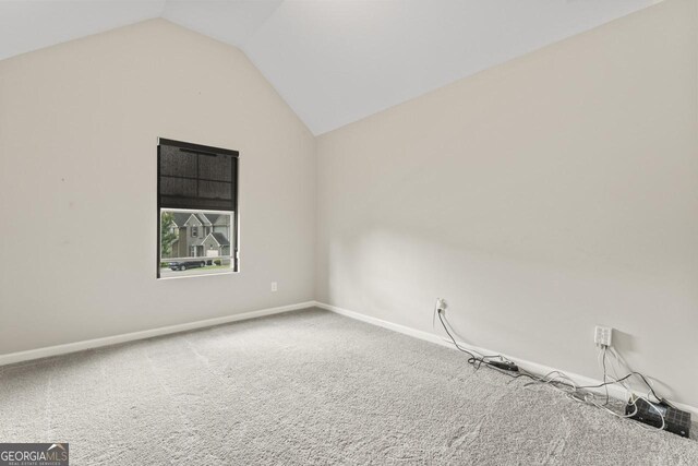 5768 Grande River Rd, Atlanta, GA 30349 - empty room with carpet floors, baseboards, and lofted ceiling