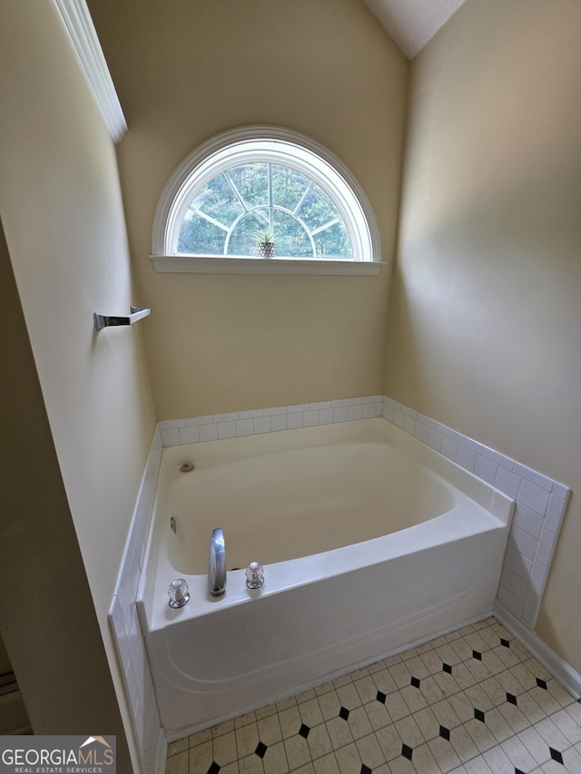 bathroom featuring tile patterned flooring and a garden tub