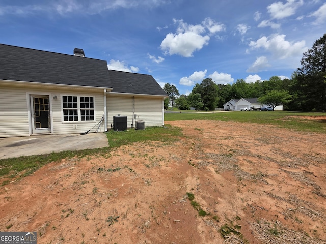 view of yard featuring central AC unit and a patio area