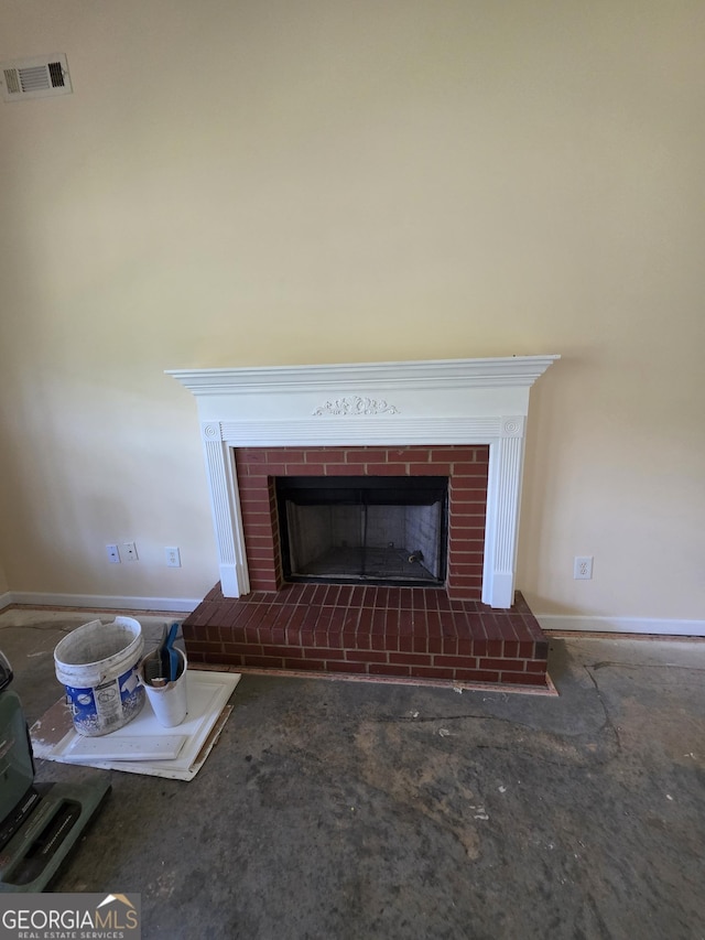 interior details with baseboards, visible vents, and a fireplace